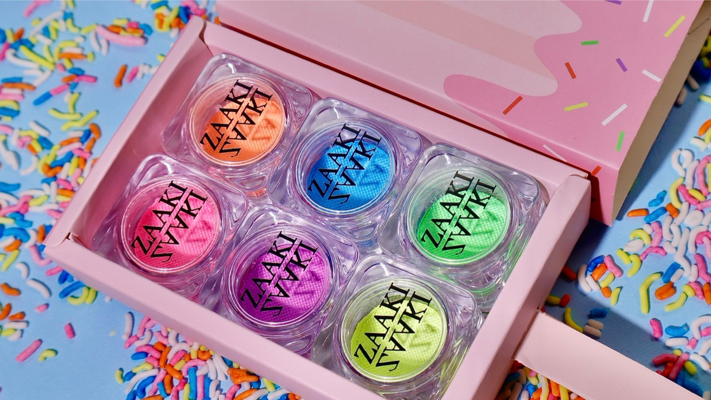 Pastel water activated eyeliner collection. Vibrant eyeliners. Side angle. Colorful pastel eyeliners in an ice cream theme box