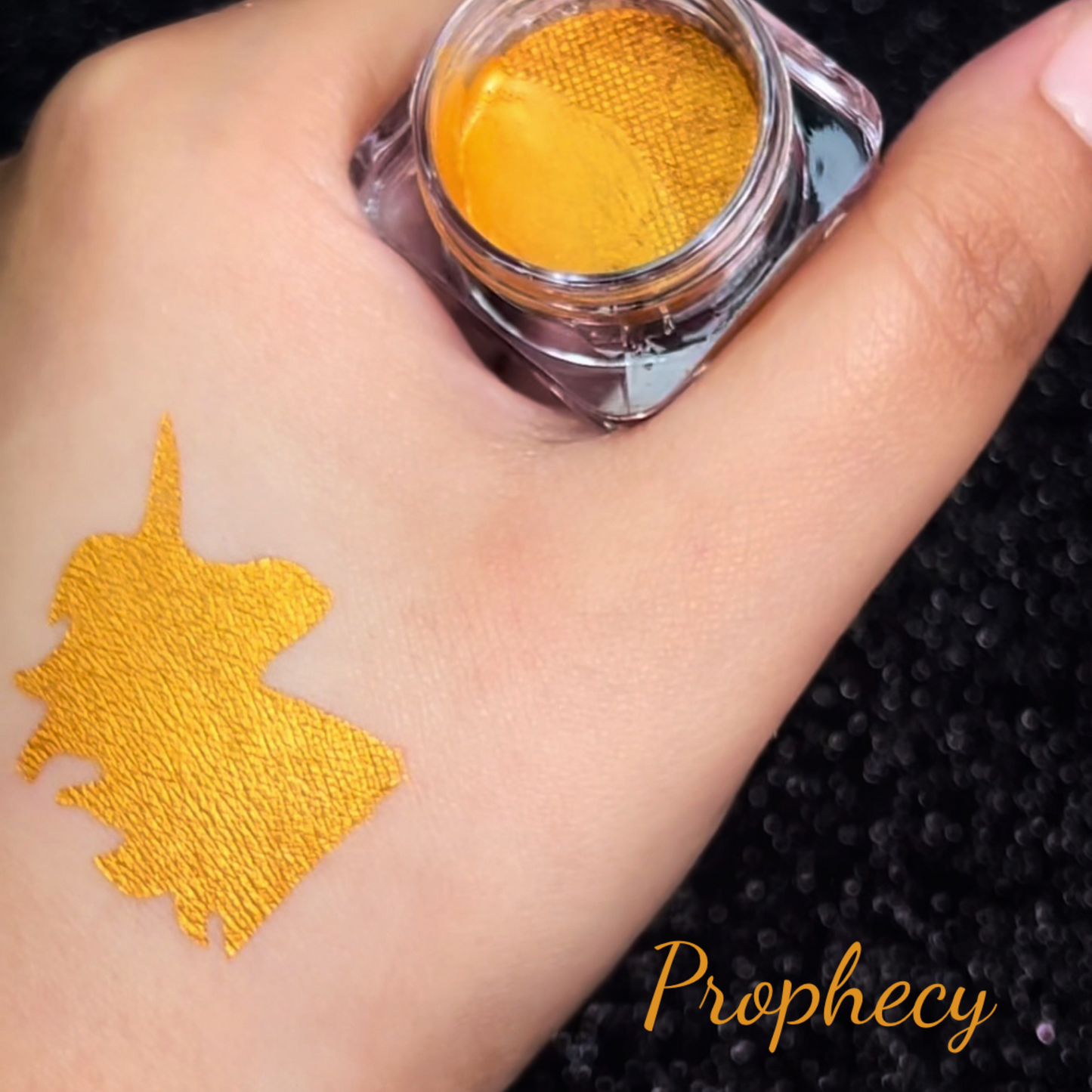 Shade swatch showing metallic eyeliner in shade prophecy. A bronze gold eyeliner 